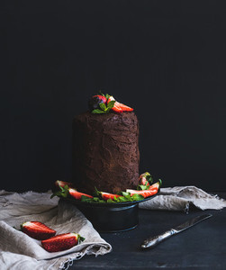 Chocolate high cake with strawberry  dark background