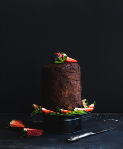 Chocolate high cake with strawberry  dark background