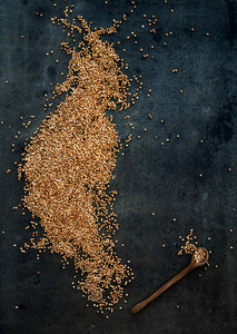 Brown buckwheat groats on dark grunge background