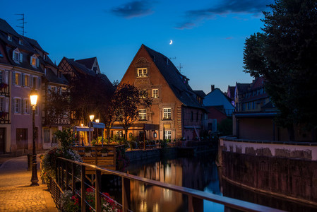 Traditional french houses on the side of chanel Petite Venise  Colmar  France  at night