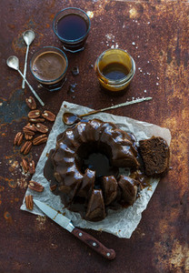 Chocolate coffee bundt cake with salt caramel icing over grunge rusty metal backdrop