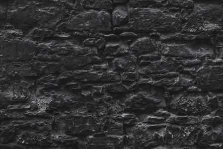 Dark brown old medieval natural stone wall  Texture  background or wallpaper