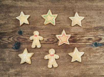Christmas homemade gingerbread cookies of man and stars over rustic wooden background  top view