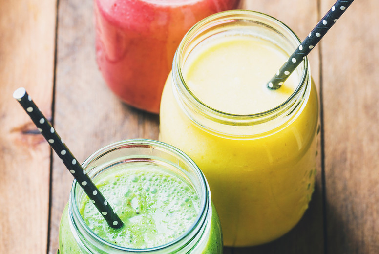 Freshly blended fruit smoothies of various colors and tastes