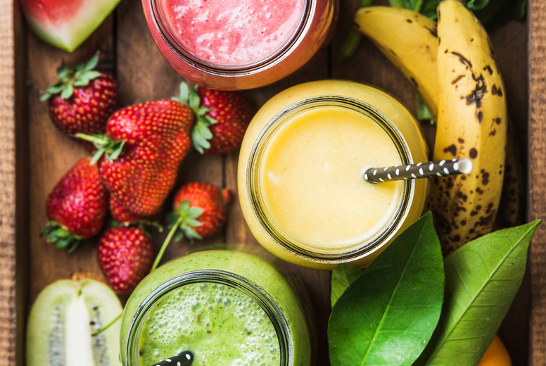 Freshly blended fruit smoothies of various colors and tastes