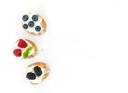 Goat cheese and berries mini sandwitches on white