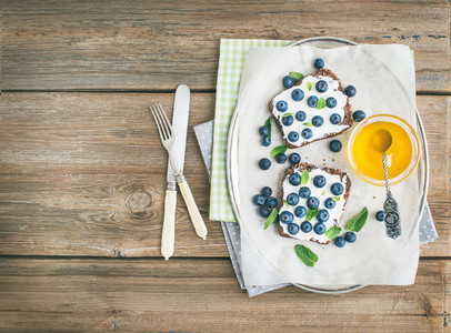 Healthy breakfast set with ricotta fresh blueberries honey and