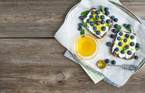 Healthy breakfast set with ricotta  fresh blueberries and honey