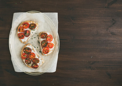 Ricotta and cherry tomato sandwiches with fresh thyme on a silve