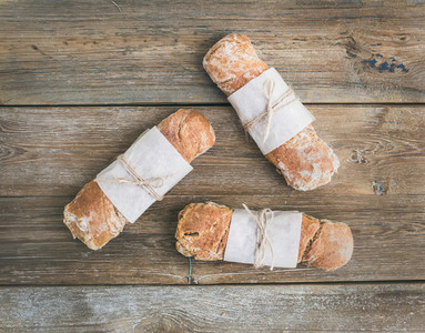 Freshly baked rustic  village bread baguette set on rough wood
