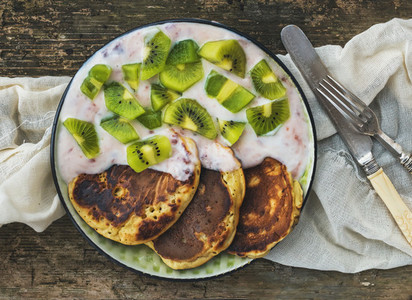 Rustic breakfast set with fluffy pancakes with strawberry yogurt