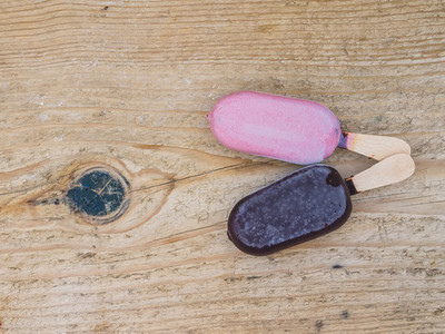 Two ice creams on a wooden board