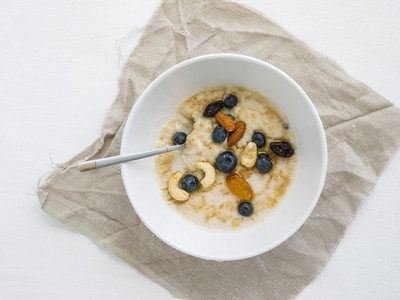 Oatmeal porridge with fresh blueberry  honey and nuts