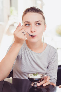 beautiful woman eating a dessert