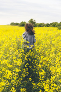 Girl running in a yellow field
