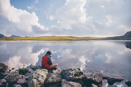 Young man near a mountain lake