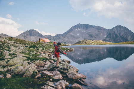 Young man near a mountain lake
