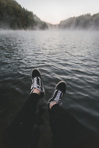 Black sneakers with the lake
