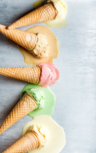 Colorful ice cream cones of different flavors Melting scoops Top view  steel metal background