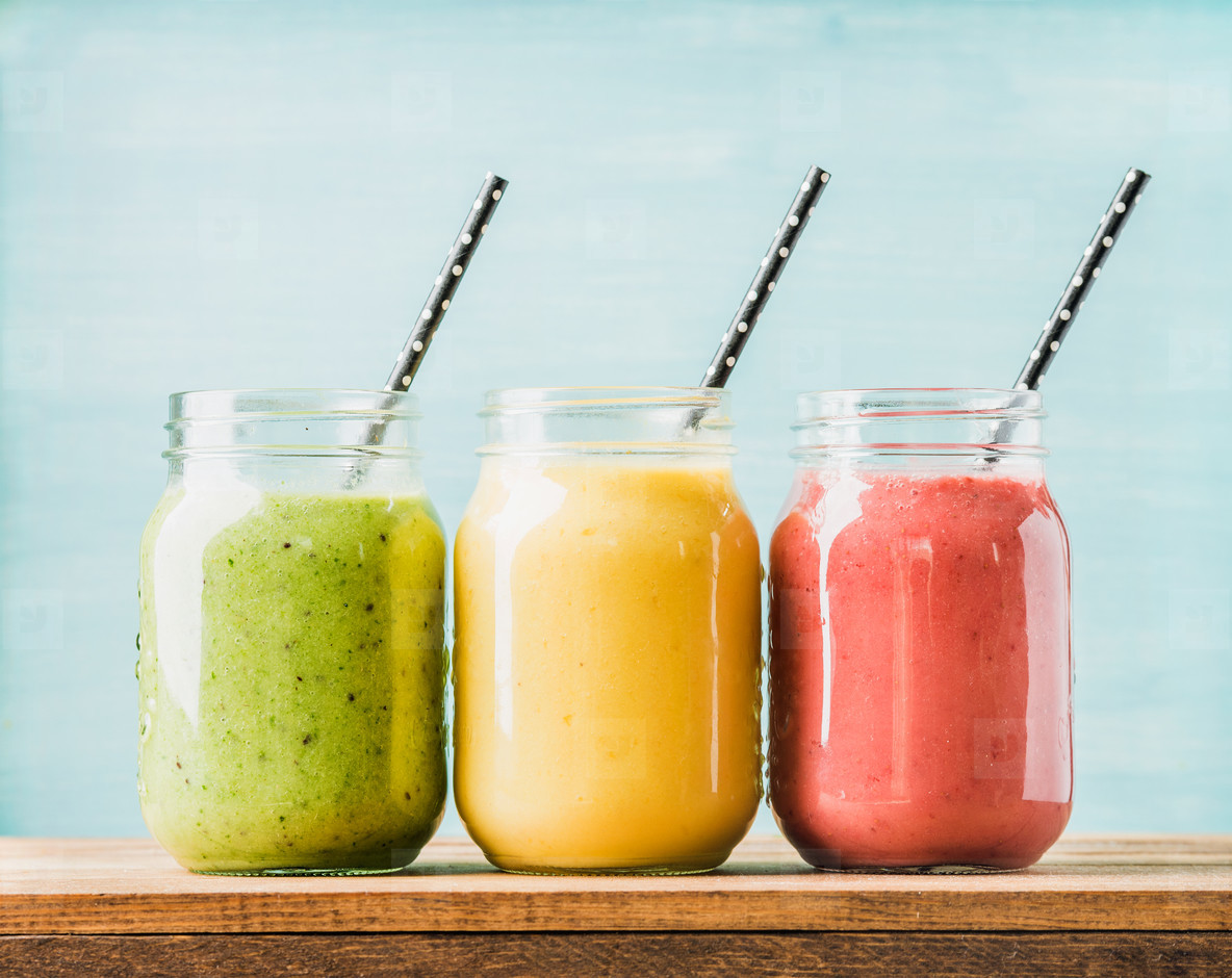 Freshly blended fruit smoothies of various colors and tastes