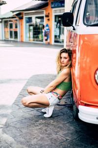 hippie girl near an orange bus
