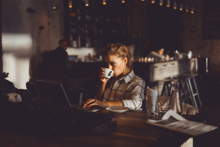 girl using laptop in cafe