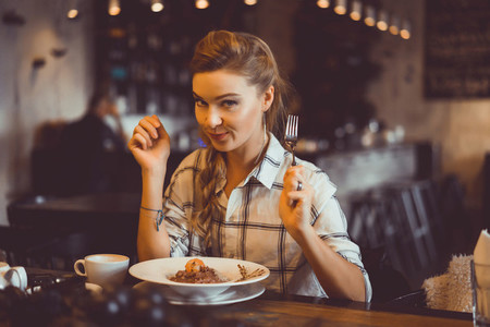 woman having dinner in a cafe