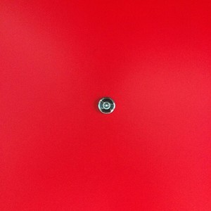 Door lens peephole on red wooden