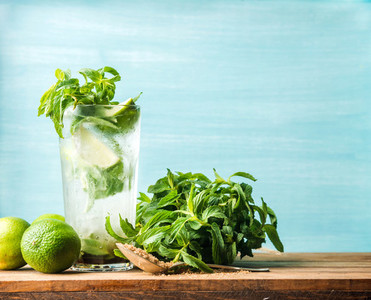 Homemade Mojito cocktail in tall glass with mint  brown sugar and limes
