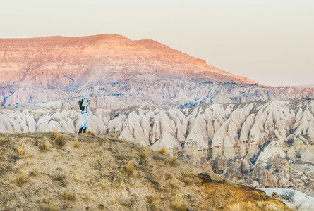 Young woman traveller hiking in mountains in Cappadocia  Turkey