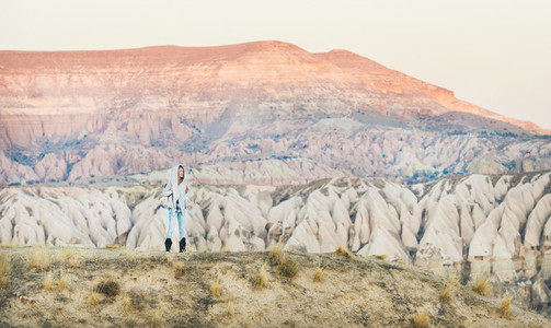 Young woman traveller hiking in mountains in Cappadocia  Central Turkey