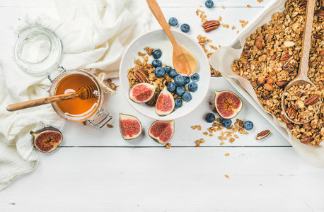 Oat granola with nuts yogurt honey fresh figs and blueberries