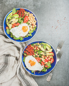 Healthy breakfast concept with fried egg  chickpea sprouts  seeds  greens