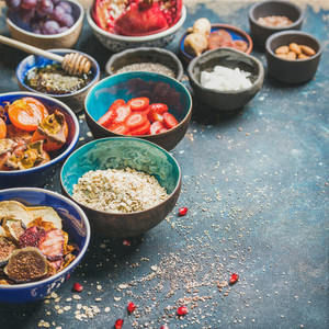 Ingredients for healthy breakfast over dark blue background square crop