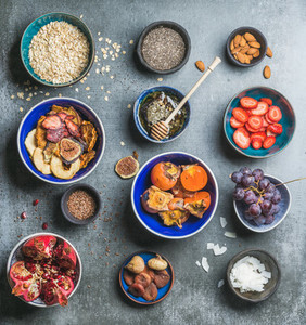 Ingredients for healthy breakfast over grey stone background