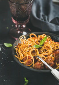 Spaghetti with meatballas fresh basil leaves and red wine