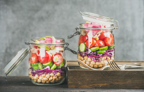 Healthy salad in jars with vegetables and chickpea sprouts