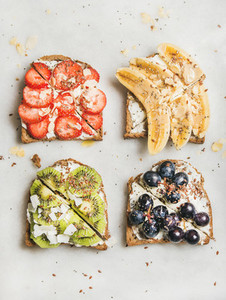 Healthy breakfast toasts with fruit  nuts and cream cheese