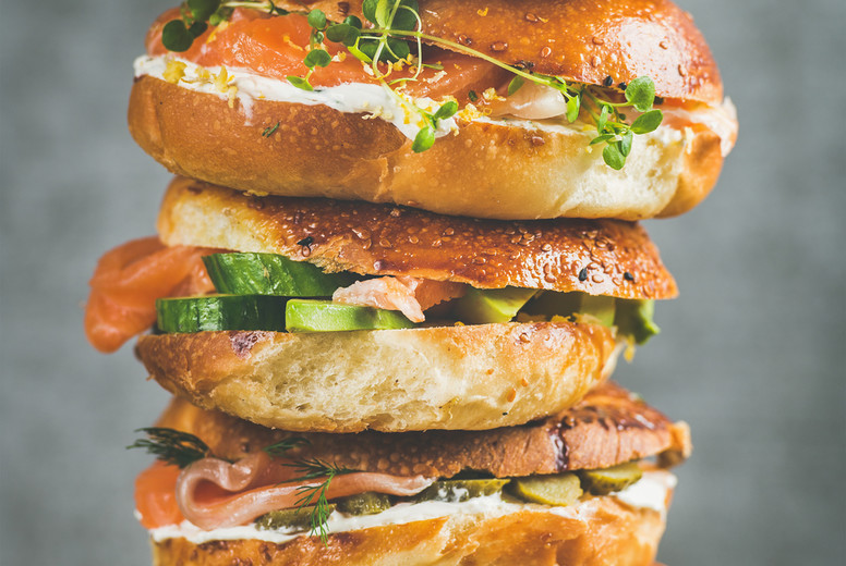 Heap of Bagels with salmon, eggs, vegetables, capers, cream-cheese, herbs