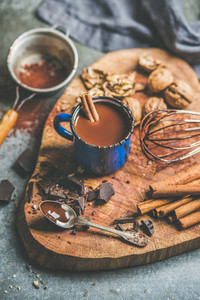 Making rich hot chocolate with cinnamon and walnuts on board