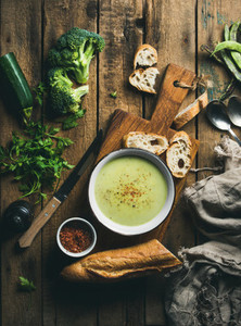 Homemade pea  broccoli  zucchini cream soup with fresh baguette