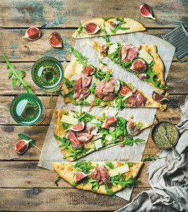 Homemade sage flatbread pizza cut into pieces with rose wine