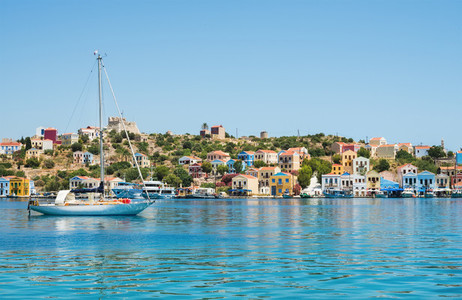 Island coast with colorful houses  clear sea water  yacht  Greece