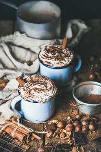 Hot chocolate with whipped cream  cinnamon sticks and nuts