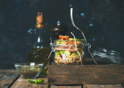 Healthy homemade jar quinoa salad with sun dried tomatoes avocado basil