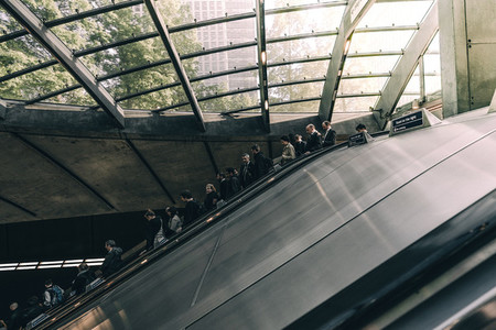 People riding down an escalator