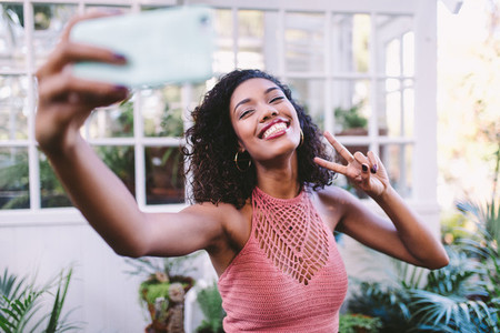 Happy african girl taking selfie