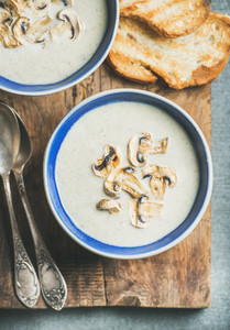 Close up of Creamy mushroom soup in bowls with toasted bread