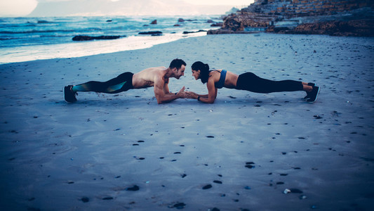 Two adults training on the beach