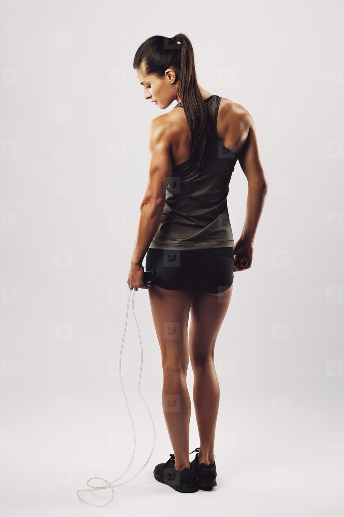Fit and muscular woman with jumping rope